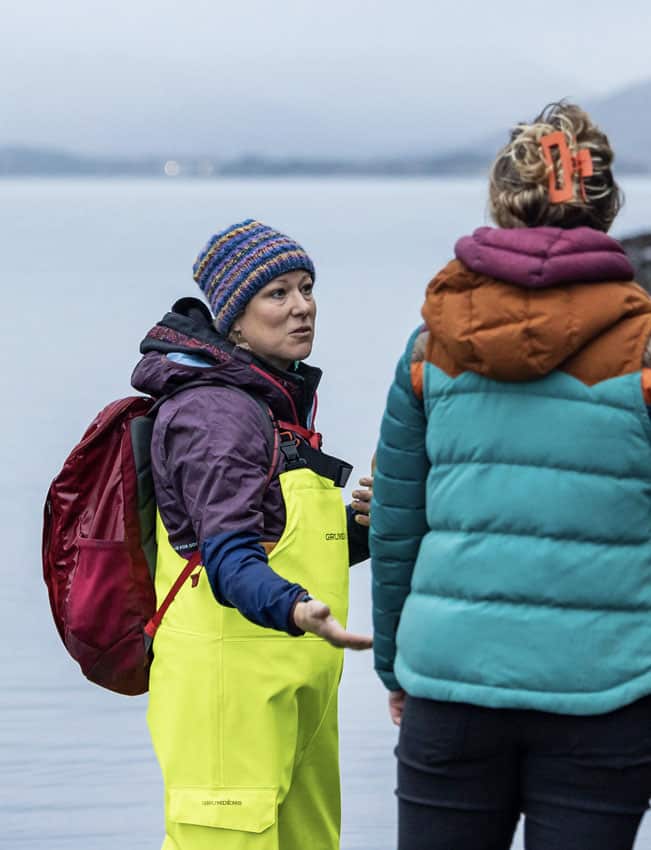 Woman wading in water with neon yellow waders